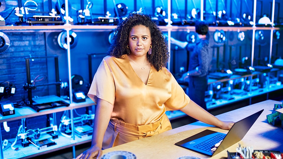 Business woman with computer looking at camera. 